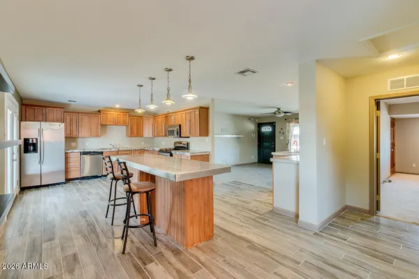a kitchen with stainless steel appliances granite countertop a stove a sink and a refrigerator