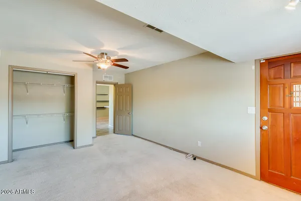 a view of a livingroom with a ceiling fan and window
