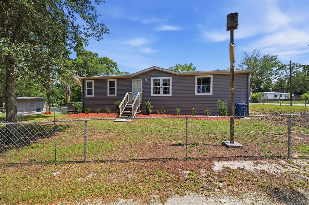 3183 Cedley Road Dade City, FL 33523 - Photo 40 of 48 a view of a house with a yard