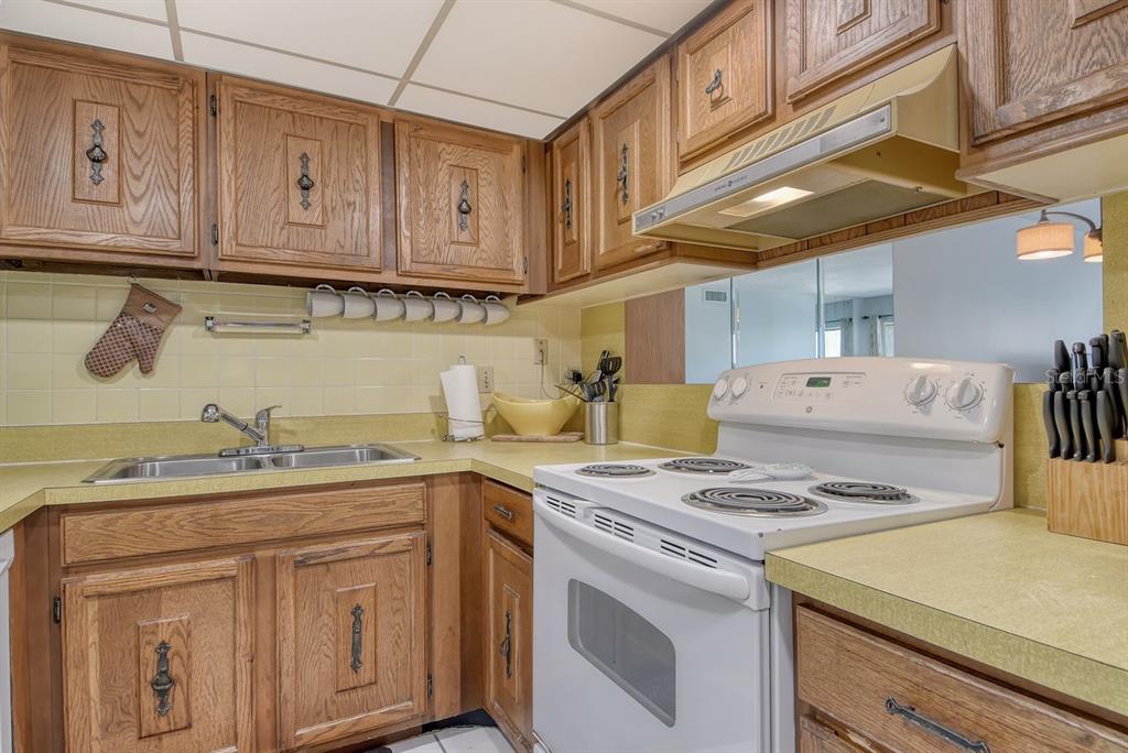6157 Midnight Pass Road, Unit E63 Sarasota, FL 34242 - Photo 20 of 61 a kitchen with stainless steel appliances granite countertop a sink stove and cabinets