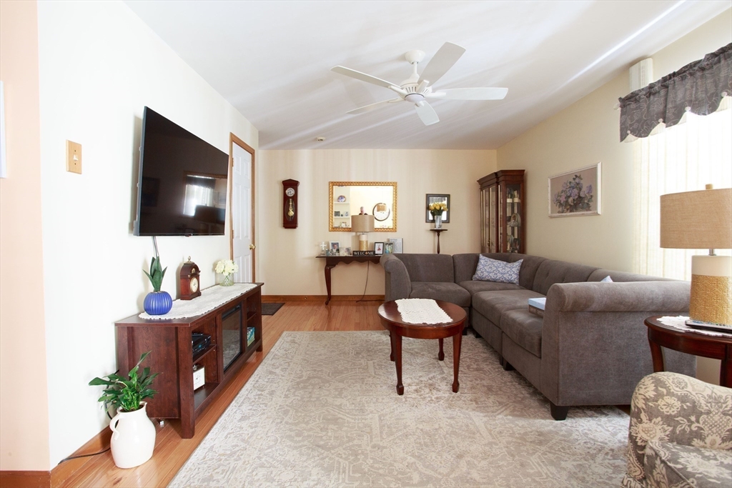 665 Center Street, Unit 311 Ludlow, MA 01056 - Photo 11 of 24 a living room with furniture and a flat screen tv