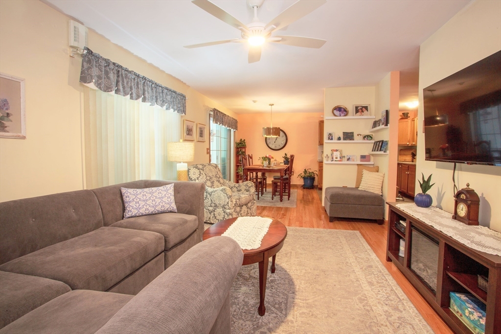 665 Center Street, Unit 311 Ludlow, MA 01056 - Photo 12 of 24 a living room with furniture and a flat screen tv
