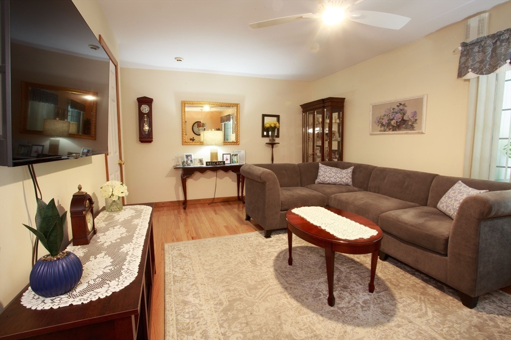 665 Center Street, Unit 311 Ludlow, MA 01056 - Photo 13 of 24 a living room with furniture and wooden floor