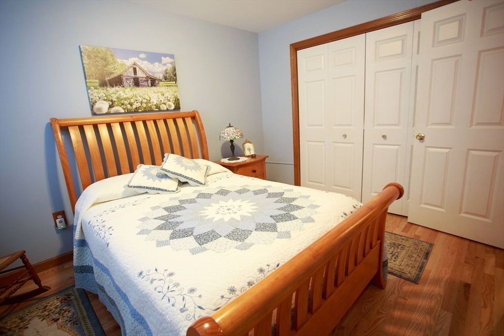 665 Center Street, Unit 311 Ludlow, MA 01056 - Photo 15 of 24 a bed sitting in a bedroom next to a window