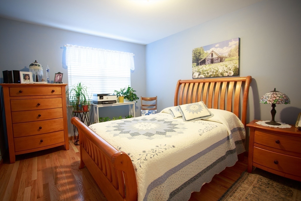 665 Center Street, Unit 311 Ludlow, MA 01056 - Photo 16 of 24 a bed room with a bed and a dresser