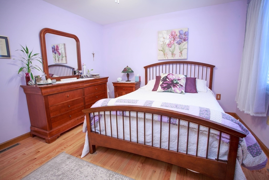 665 Center Street, Unit 311 Ludlow, MA 01056 - Photo 18 of 24 a bedroom with a bed and a dresser