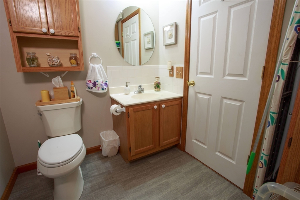 665 Center Street, Unit 311 Ludlow, MA 01056 - Photo 19 of 24 a white toilet sitting next to a bathroom sink