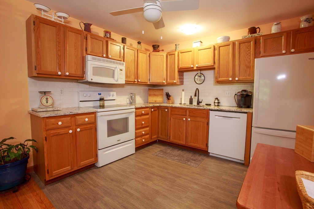 665 Center Street, Unit 311 Ludlow, MA 01056 - Photo 3 of 24 a kitchen with a sink a stove and cabinets