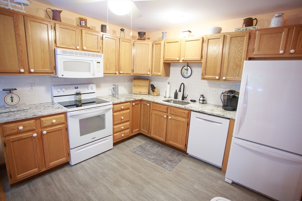 665 Center Street, Unit 311 Ludlow, MA 01056 - Photo 7 of 24 a kitchen with cabinets a sink and appliances