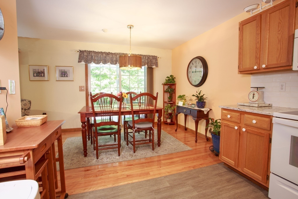 665 Center Street, Unit 311 Ludlow, MA 01056 - Photo 8 of 24 a view of a dining room with furniture window and outside view