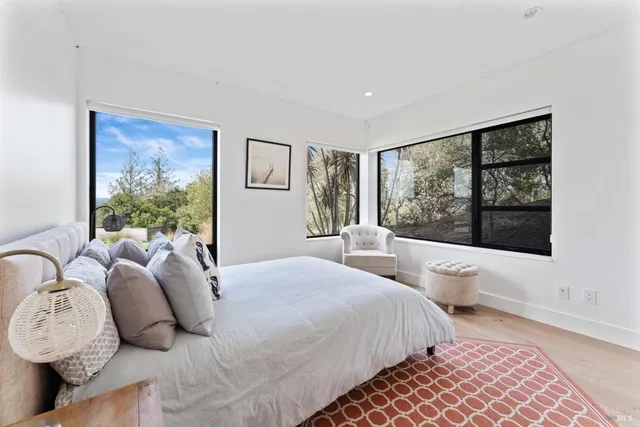 a bedroom with bed and a large window