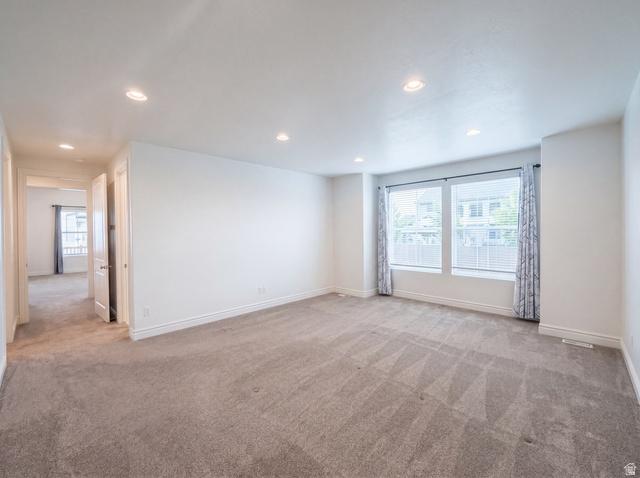 1251 North 2525 West Clinton, UT 84015 - Photo 13 of 30 Spacious room featuring neutral carpeting, multiple recessed ceiling lights, and two large windows with blinds and curtains