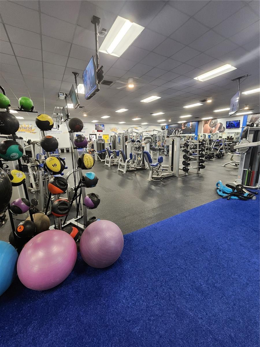 296 Racquet Club Road, Unit 203 Weston, FL 33326 - Photo 38 of 43 a view of a room with gym equipment