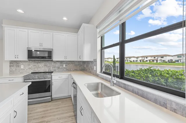 a bathroom with a granite countertop sink and a bathtub