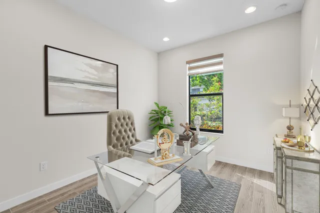 a kitchen with kitchen island white cabinets and stainless steel appliances