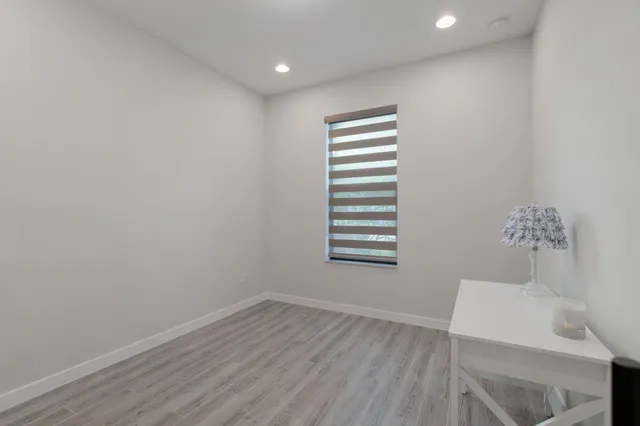 a bathroom with a sink mirror and toilet