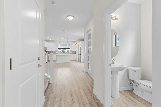 a view of staircase with railing and white walls