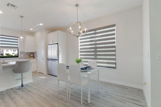 an empty room with a ceiling fan and a window