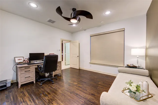 a view of a livingroom with workspace and a window