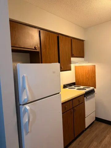 a kitchen with a refrigerator and a stove