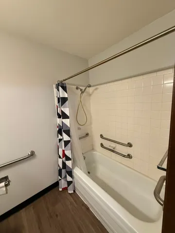 a bathroom with a bathtub and a shower