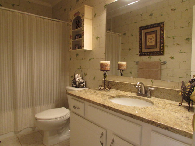 420 Fairview Church Road Forsyth, GA 31029 - Photo 11 of 12 a bathroom with a granite countertop sink toilet and shower