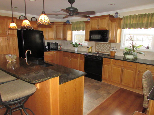 420 Fairview Church Road Forsyth, GA 31029 - Photo 3 of 12 a kitchen with granite countertop a sink a counter top space cabinets and stainless steel appliances