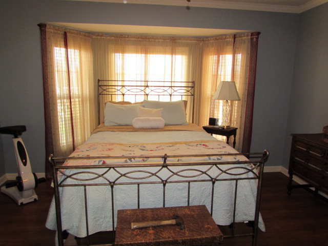 420 Fairview Church Road Forsyth, GA 31029 - Photo 7 of 12 a bedroom with a bed a window and chair