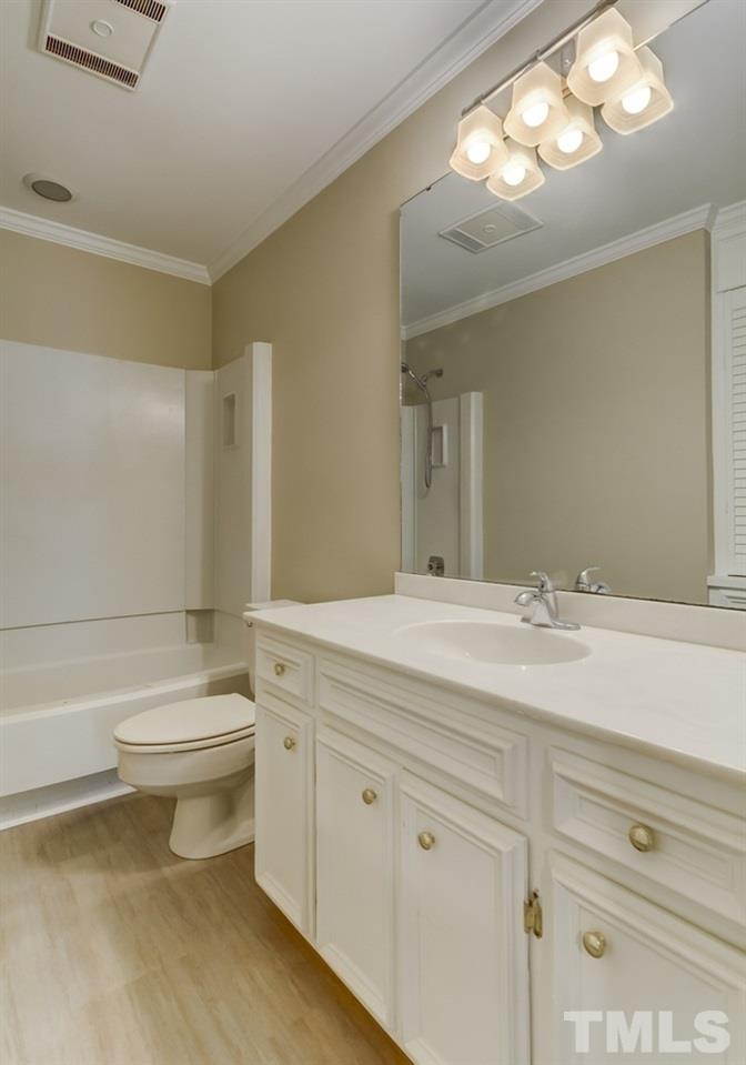 2921 Rue Sans Famille Raleigh, NC 27607 - Photo 11 of 15 a bathroom with a sink a toilet and a mirror