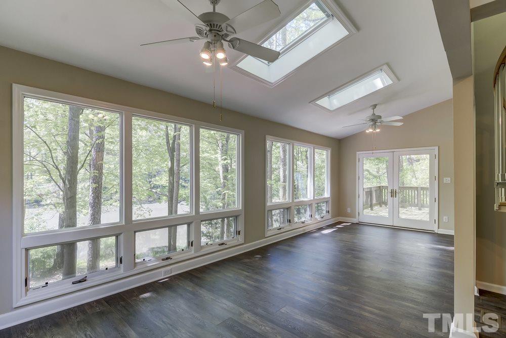 2921 Rue Sans Famille Raleigh, NC 27607 - Photo 4 of 15 a view of an empty room with wooden floor and a window