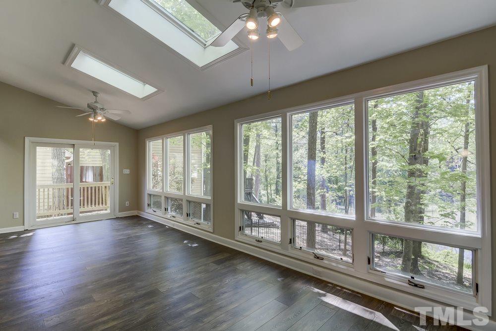 2921 Rue Sans Famille Raleigh, NC 27607 - Photo 5 of 15 a view of an empty room with wooden floor and a window