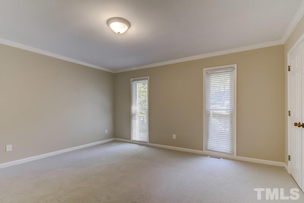 2921 Rue Sans Famille Raleigh, NC 27607 - Photo 10 of 15 an empty room with closet area and windows