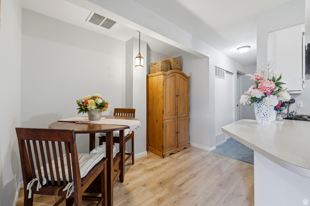 1175 Canyon Road, Unit 86 Ogden, UT 84404 - Photo 16 of 29 Dining area featuring wood-finish flooring and a built-in pendant light fixture
