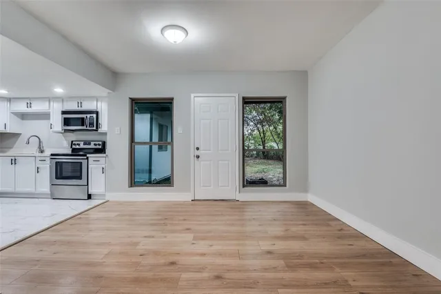a view of a kitchen with a sink and a refrigerator