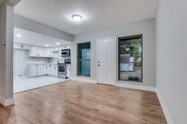 a view of a kitchen with a sink and a large window