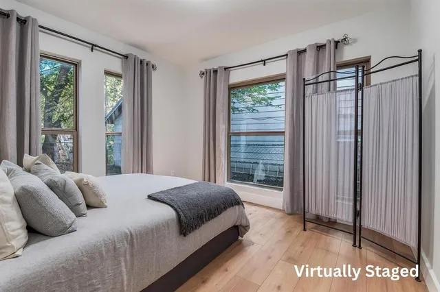 a bedroom with a bed and a window