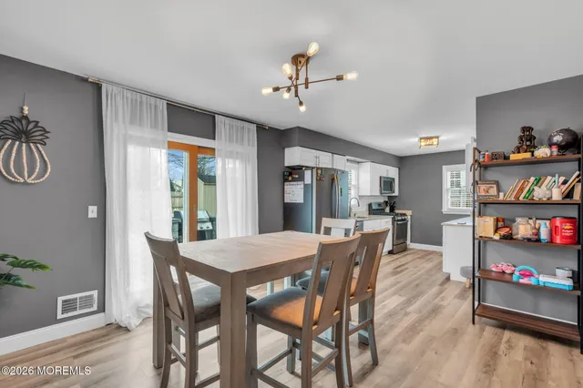 a view of a dining room with furniture and a book shelf