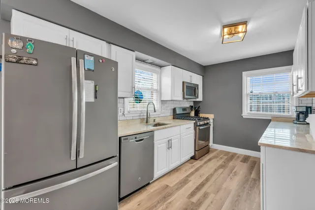 a kitchen with a refrigerator sink and stove