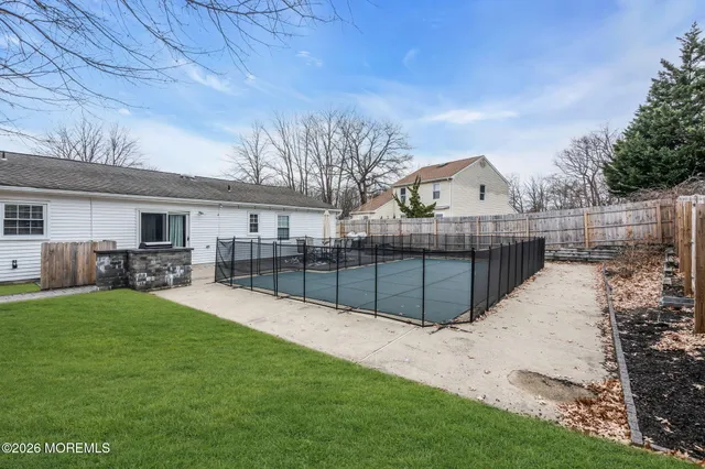 a view of a backyard with a garden and tree