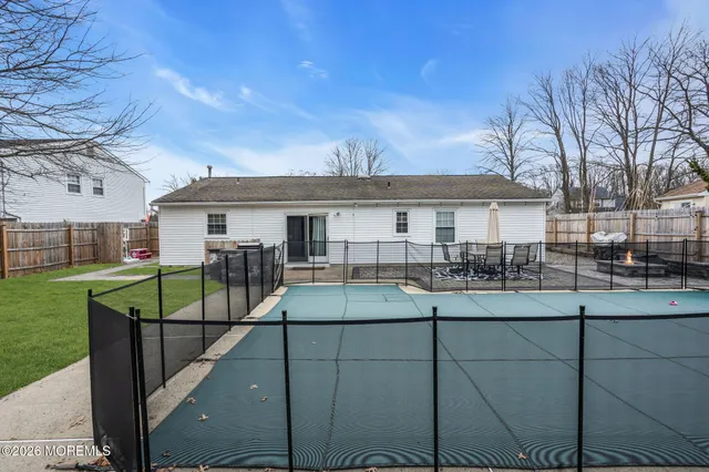 a view of a house with backyard and sitting area