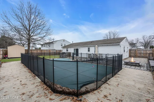 a view of a house with a wooden fence
