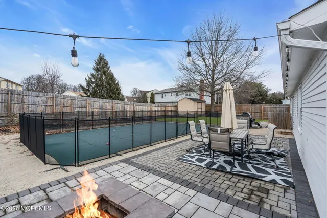 a view of a backyard with sitting area