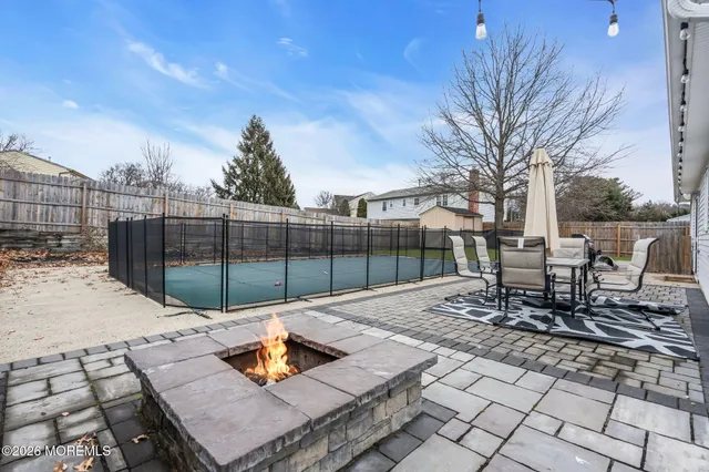 a view of a patio with a table and chairs