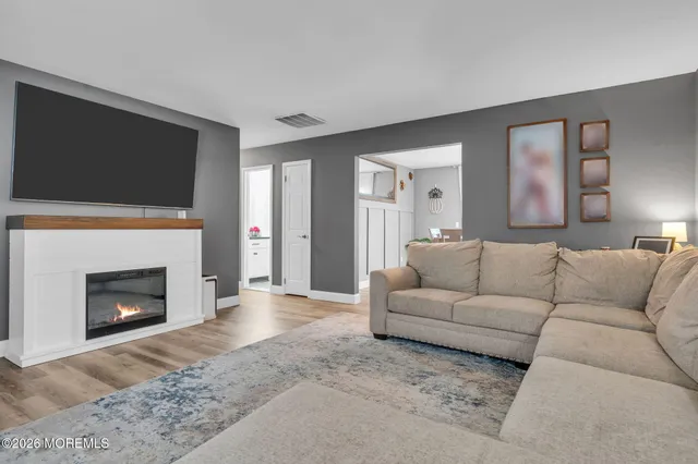 a living room with furniture a fireplace and a flat screen tv