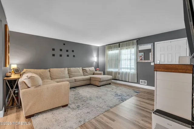 a living room with furniture and a rug
