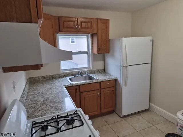 a kitchen with sink cabinets and window