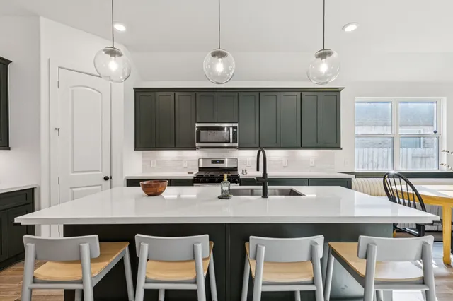 a kitchen with a sink cabinets and window
