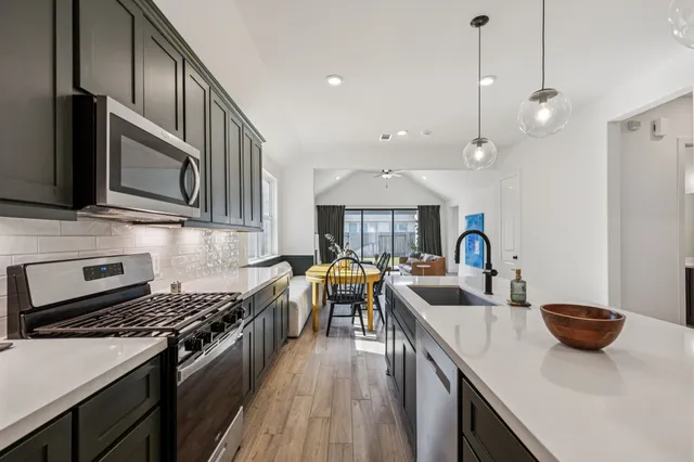 a kitchen with a sink a stove and a refrigerator