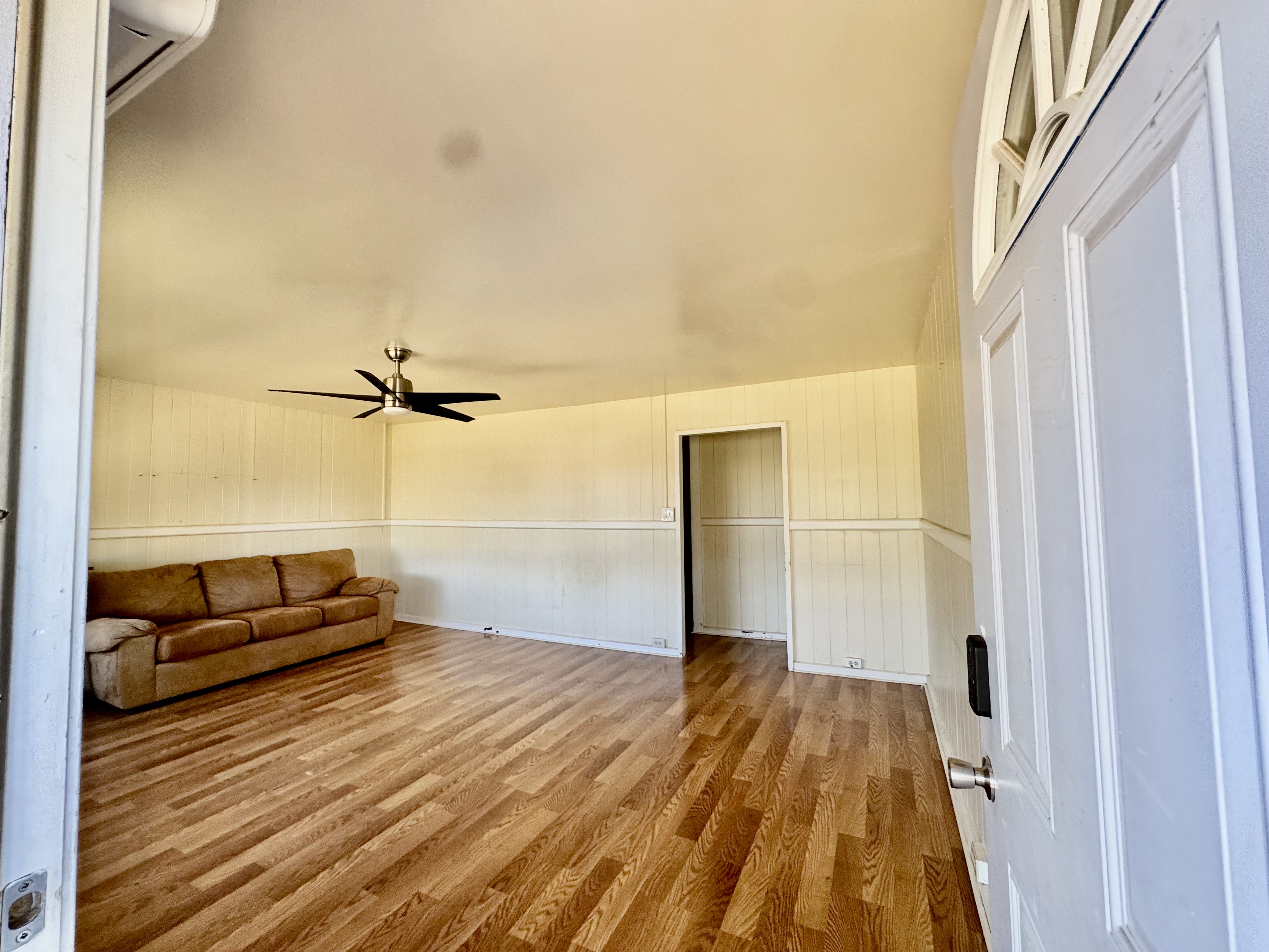 4611 Menehune Road, Unit 2 Waimea, HI 96796 - Photo 11 of 25 a view of a room with wooden floor and windows
