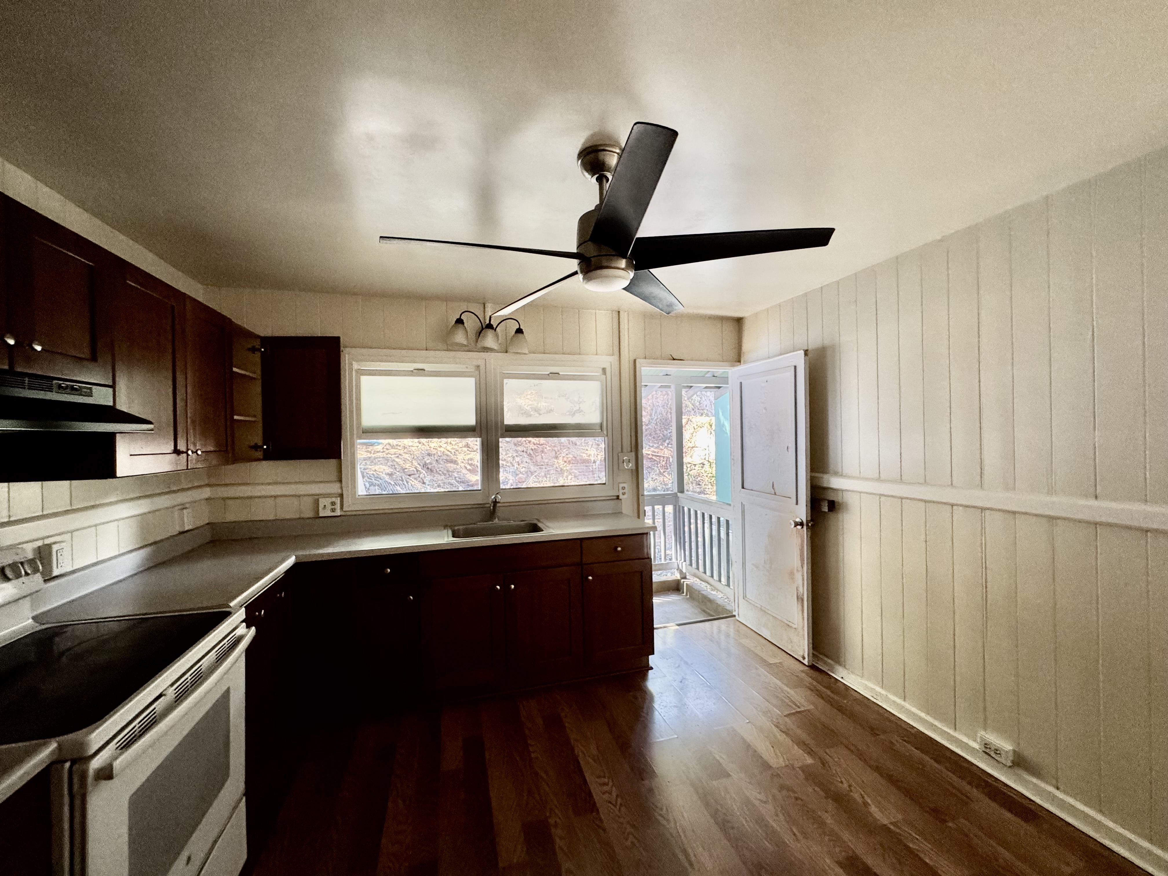 4611 Menehune Road, Unit 2 Waimea, HI 96796 - Photo 14 of 25 a kitchen with a sink a counter space appliances and cabinets